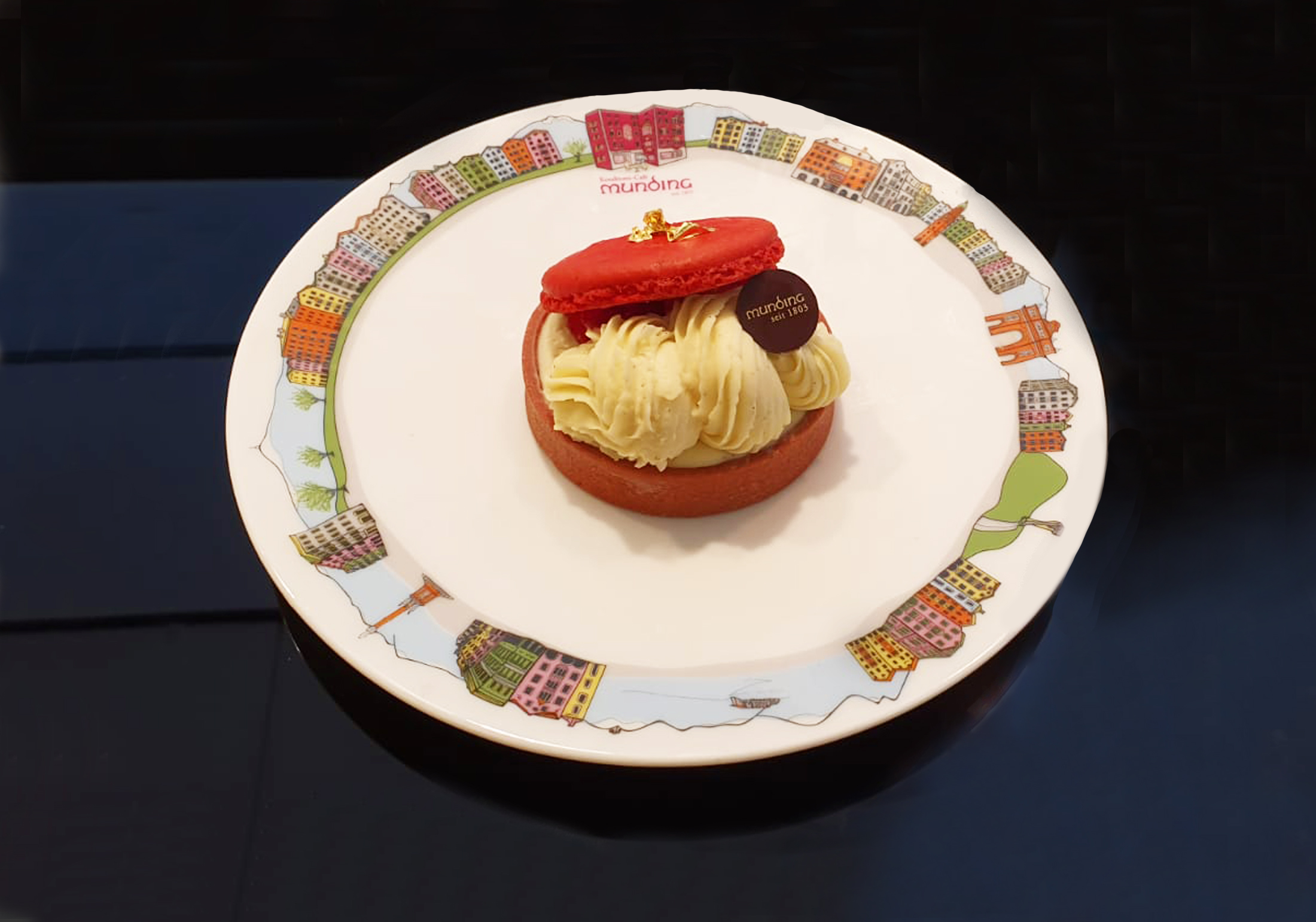 Munding’s handmade pastry served on a plate decorated with Innsbruck’s colourful houses